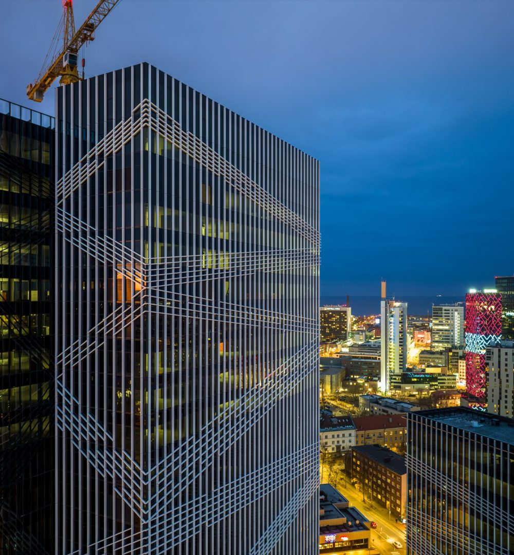 High-rise with a patterned glass facade at night