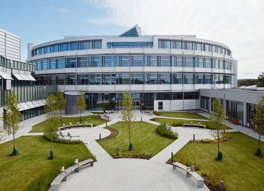 White office building with a landscaped courtyard